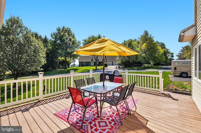 wooden terrace featuring a yard