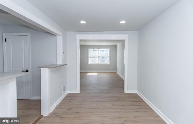 hallway with light wood-type flooring