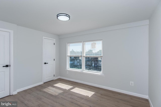 empty room with hardwood / wood-style floors