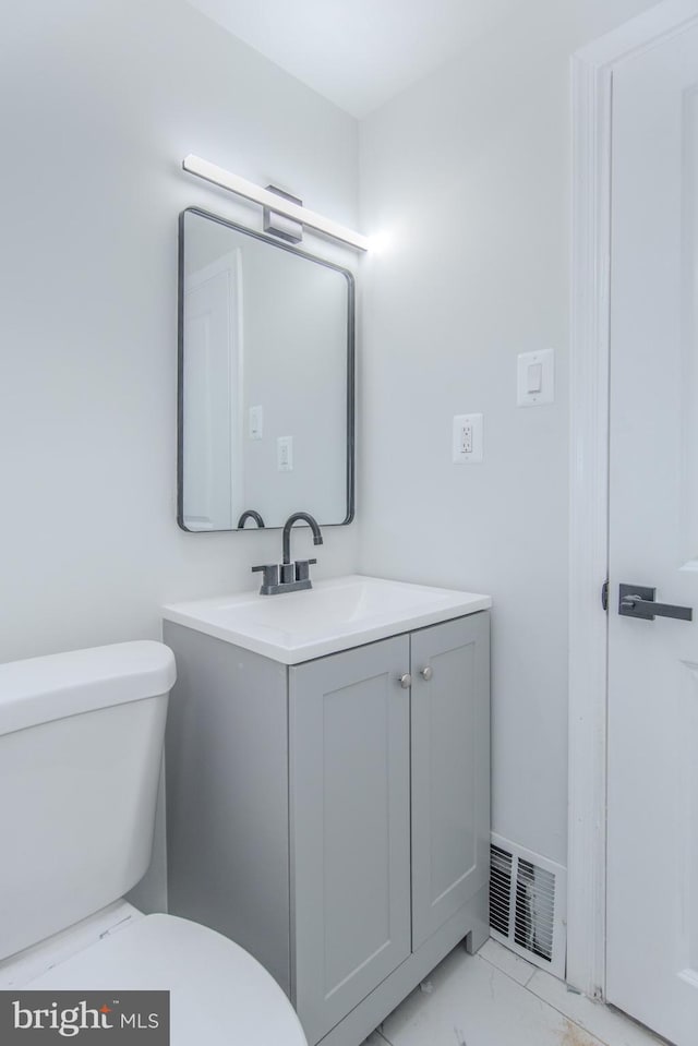 bathroom featuring vanity and toilet