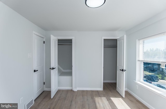 unfurnished bedroom with light wood-type flooring