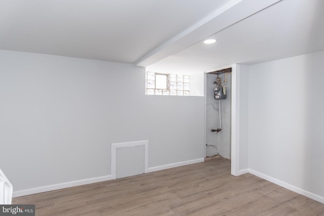 basement with light hardwood / wood-style floors