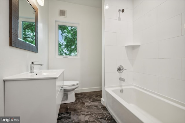 full bathroom featuring vanity, toilet, and tiled shower / bath