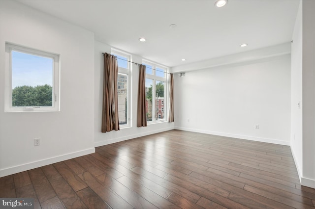 spare room featuring dark hardwood / wood-style flooring