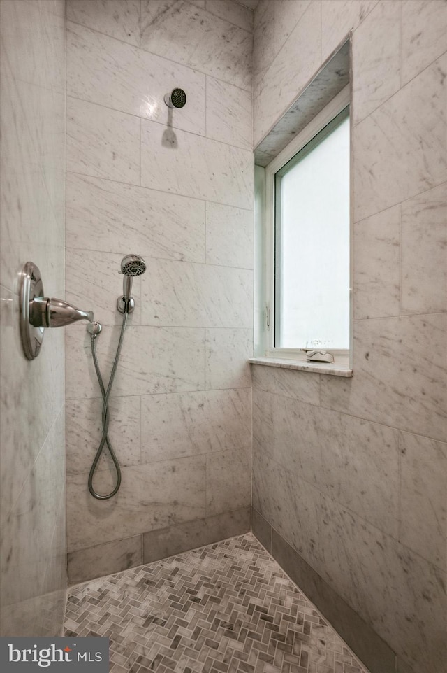 bathroom with tiled shower