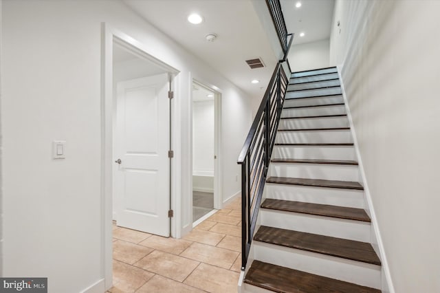 stairway featuring tile patterned flooring