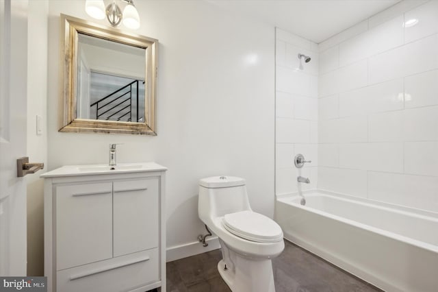 full bathroom with tiled shower / bath, vanity, and toilet