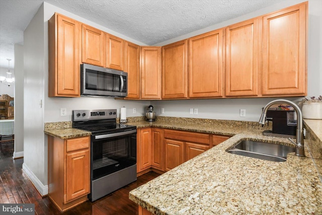 6330 Kleineidam Way, Spotsylvania, VA 22551 - kitchen featuring baseboards, light stone counters, a sink, appliances with stainless steel finishes, and dark wood-style floors