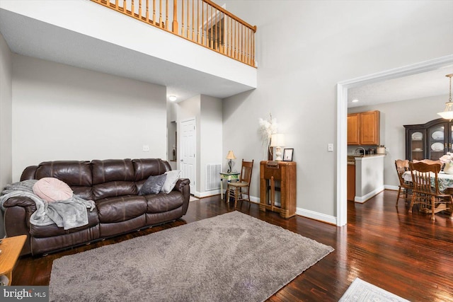 6330 Kleineidam Way, Spotsylvania, VA 22551 - living area featuring baseboards, dark wood finished floors, visible vents, and a high ceiling