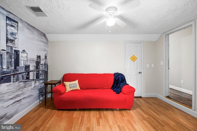6330 Kleineidam Way, Spotsylvania, VA 22551 - living room featuring wood finished floors, a textured ceiling, visible vents, a ceiling fan, and baseboards