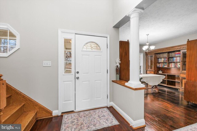 6330 Kleineidam Way, Spotsylvania, VA 22551 - foyer with wood finished floors, a notable chandelier, baseboards, and decorative columns