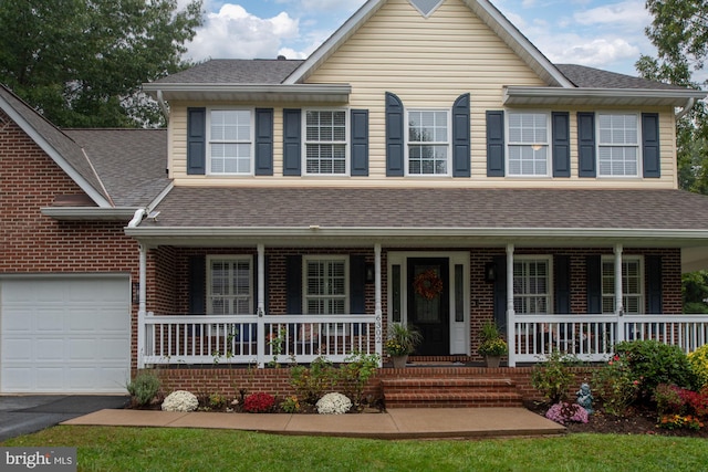 view of front of home featuring a porch and a garage