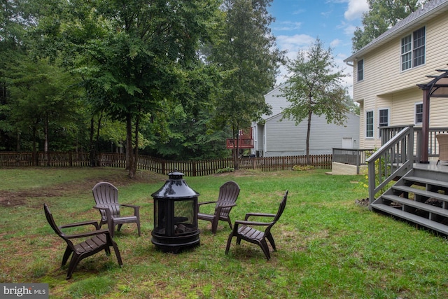 view of yard with a fire pit and a deck