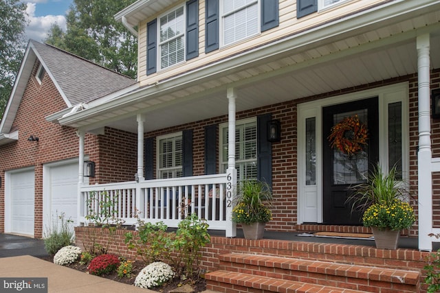 exterior space featuring covered porch and a garage