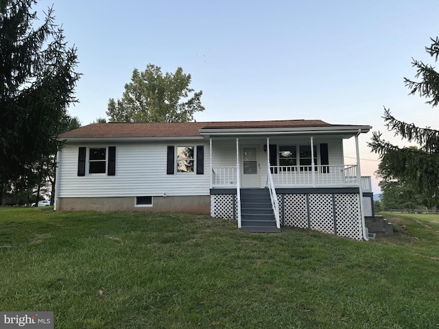 view of front of house featuring a yard and covered porch