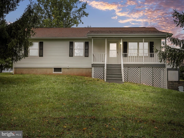 view of front of house with a lawn and covered porch