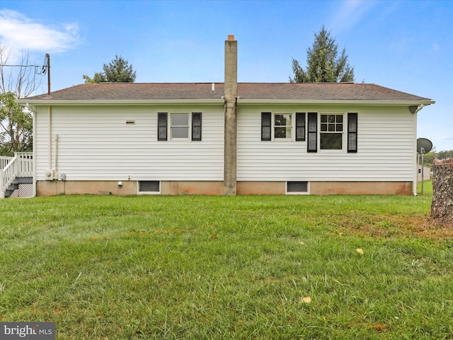 back of property featuring a lawn