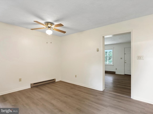 empty room featuring ceiling fan, a baseboard radiator, dark wood-type flooring, and a textured ceiling