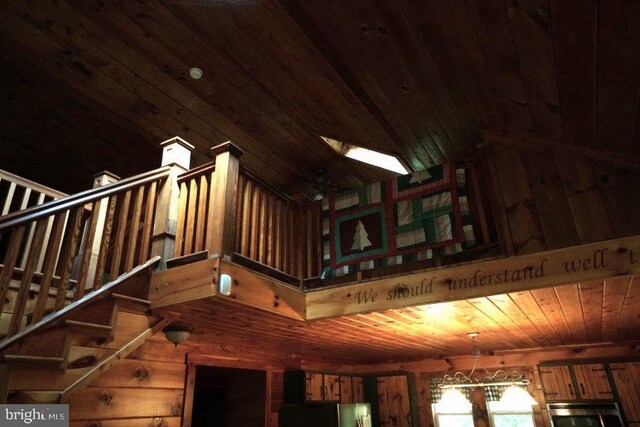 interior space featuring wood walls, wood ceiling, oven, and a skylight