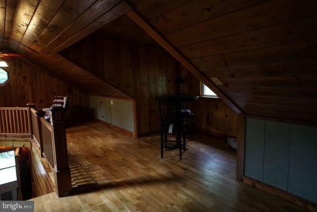 bonus room with vaulted ceiling, wood walls, wooden ceiling, and hardwood / wood-style flooring