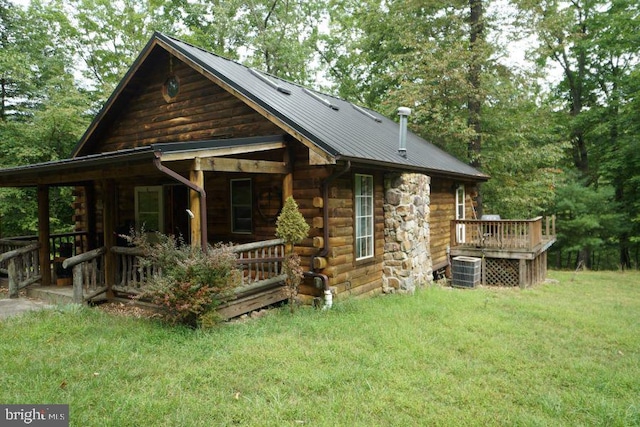 back of house featuring cooling unit, a yard, and a deck