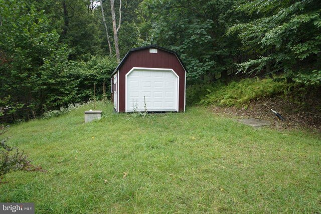 exterior space with a garage and a lawn