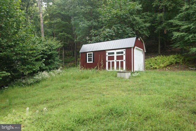 view of outbuilding featuring a yard