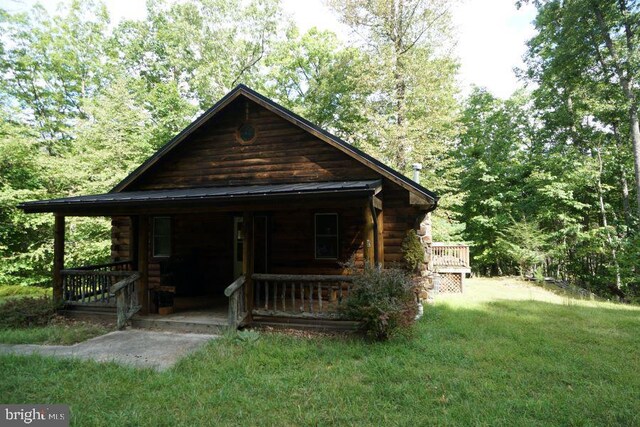 log home with a front yard and a porch