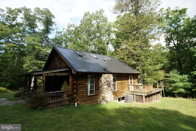 back of property featuring central AC, a yard, and a deck