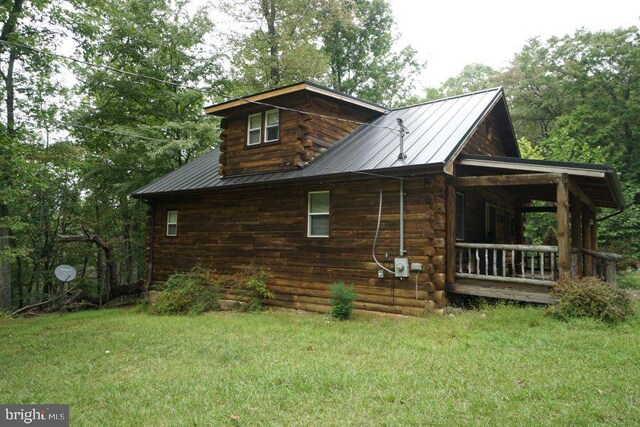 view of home's exterior featuring a porch and a yard