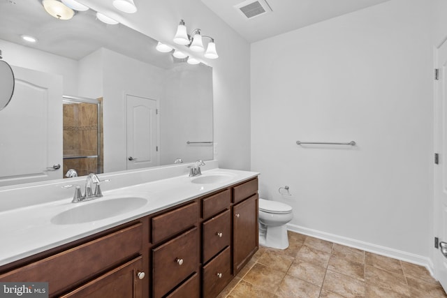 bathroom featuring vanity, a shower, toilet, and tile patterned floors