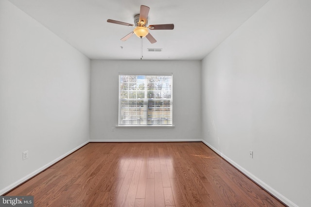 spare room with ceiling fan and hardwood / wood-style flooring