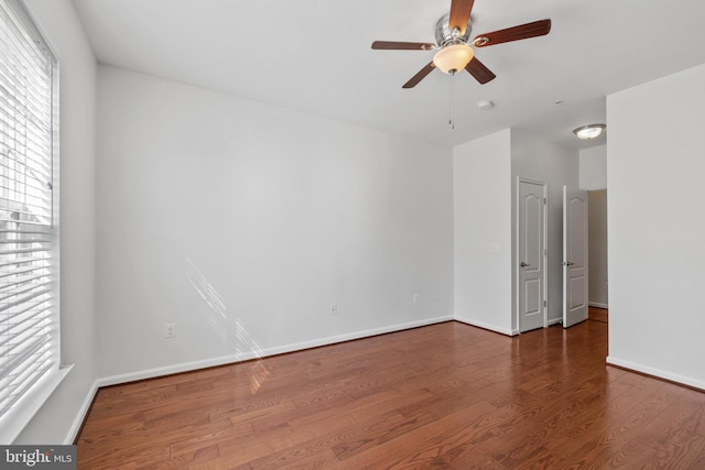 spare room with hardwood / wood-style floors and ceiling fan