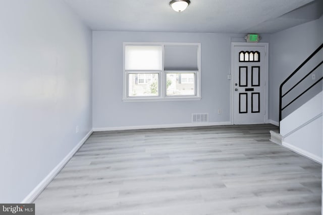 spare room with light hardwood / wood-style floors