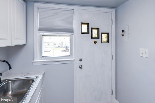 interior space with cabinets and sink