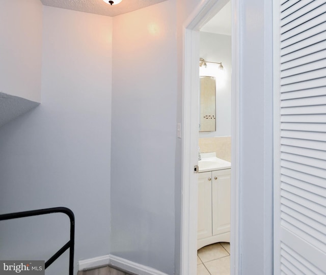 bathroom featuring a textured ceiling, vanity, and tile patterned floors