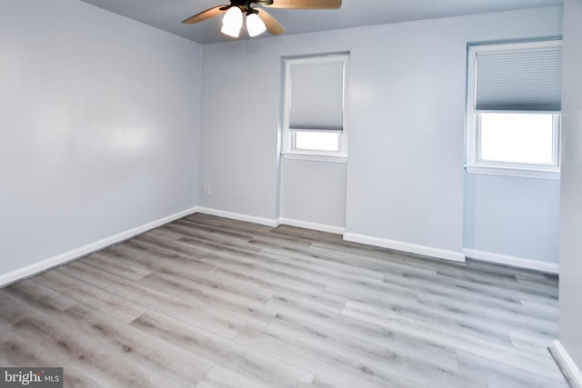 unfurnished room with a healthy amount of sunlight, ceiling fan, and light wood-type flooring