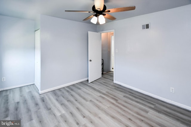 empty room with ceiling fan and light wood-type flooring