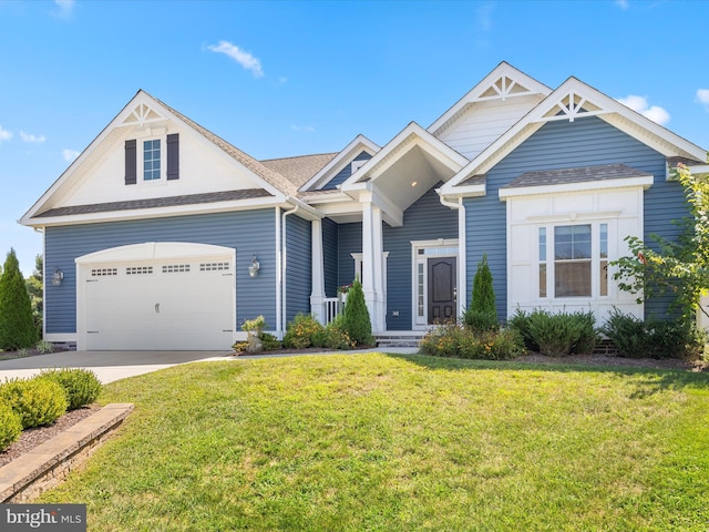 view of front of property with a front lawn and a garage