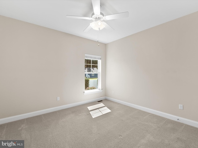 spare room with ceiling fan and carpet floors