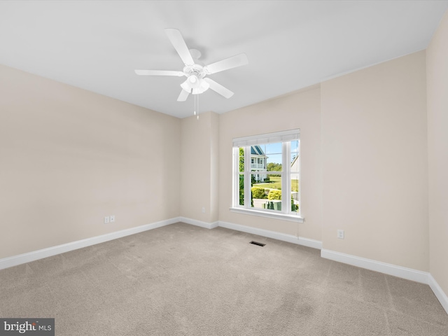 carpeted spare room with ceiling fan