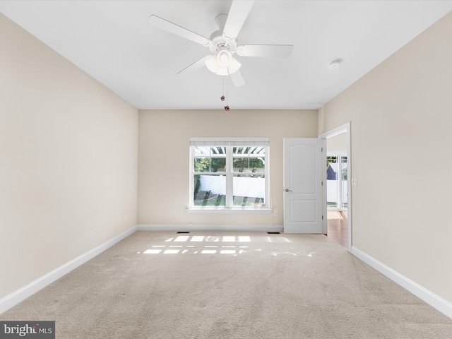 empty room featuring light carpet and ceiling fan