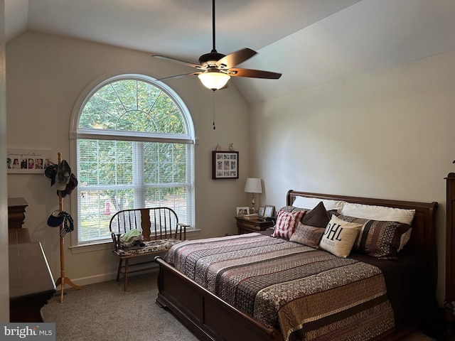 bedroom with carpet, vaulted ceiling, multiple windows, and ceiling fan