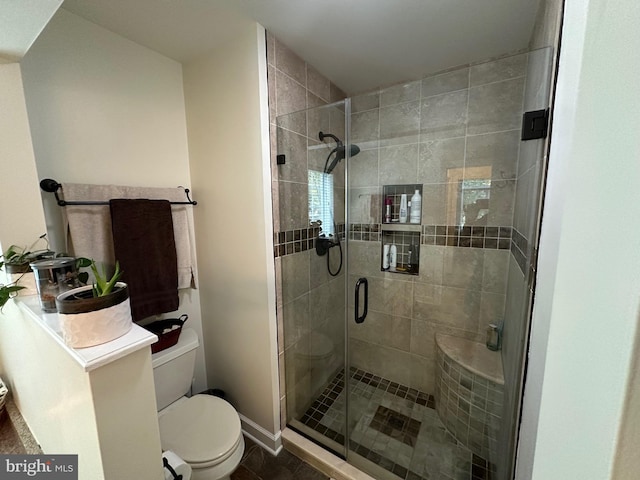 bathroom with toilet and an enclosed shower