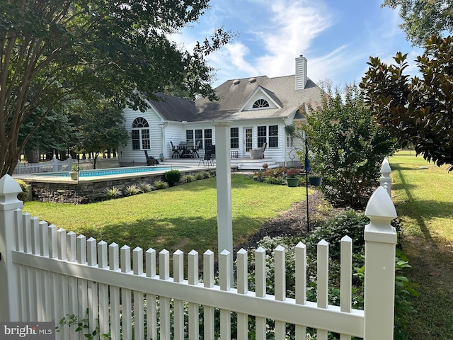 rear view of house featuring a lawn