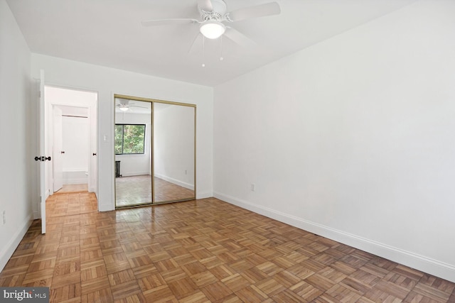 unfurnished bedroom with a closet, ceiling fan, and light parquet flooring