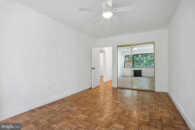 spare room with ceiling fan and light parquet floors