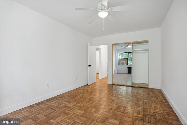 empty room with light parquet flooring and ceiling fan