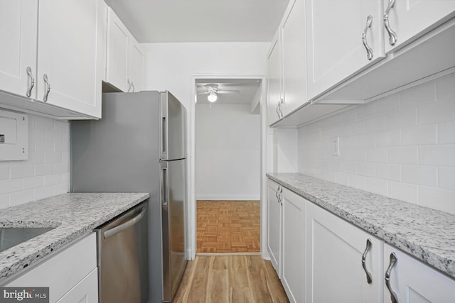 kitchen featuring dishwasher, ceiling fan, white cabinetry, and tasteful backsplash