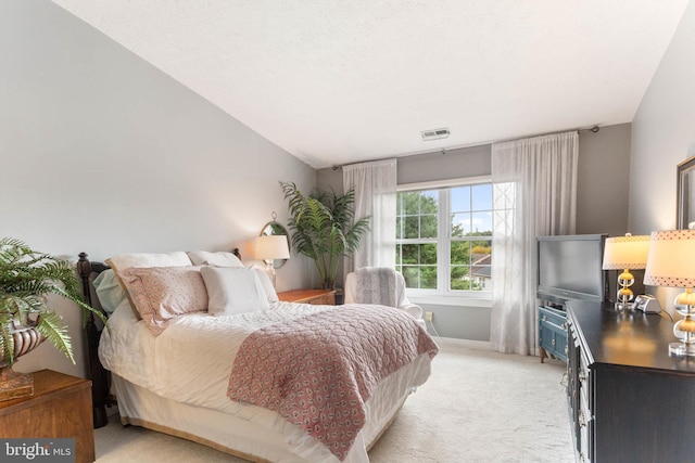 bedroom with lofted ceiling and light colored carpet